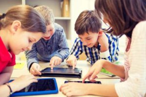 Niños con tablets en una actividad extraescolar tecnológica